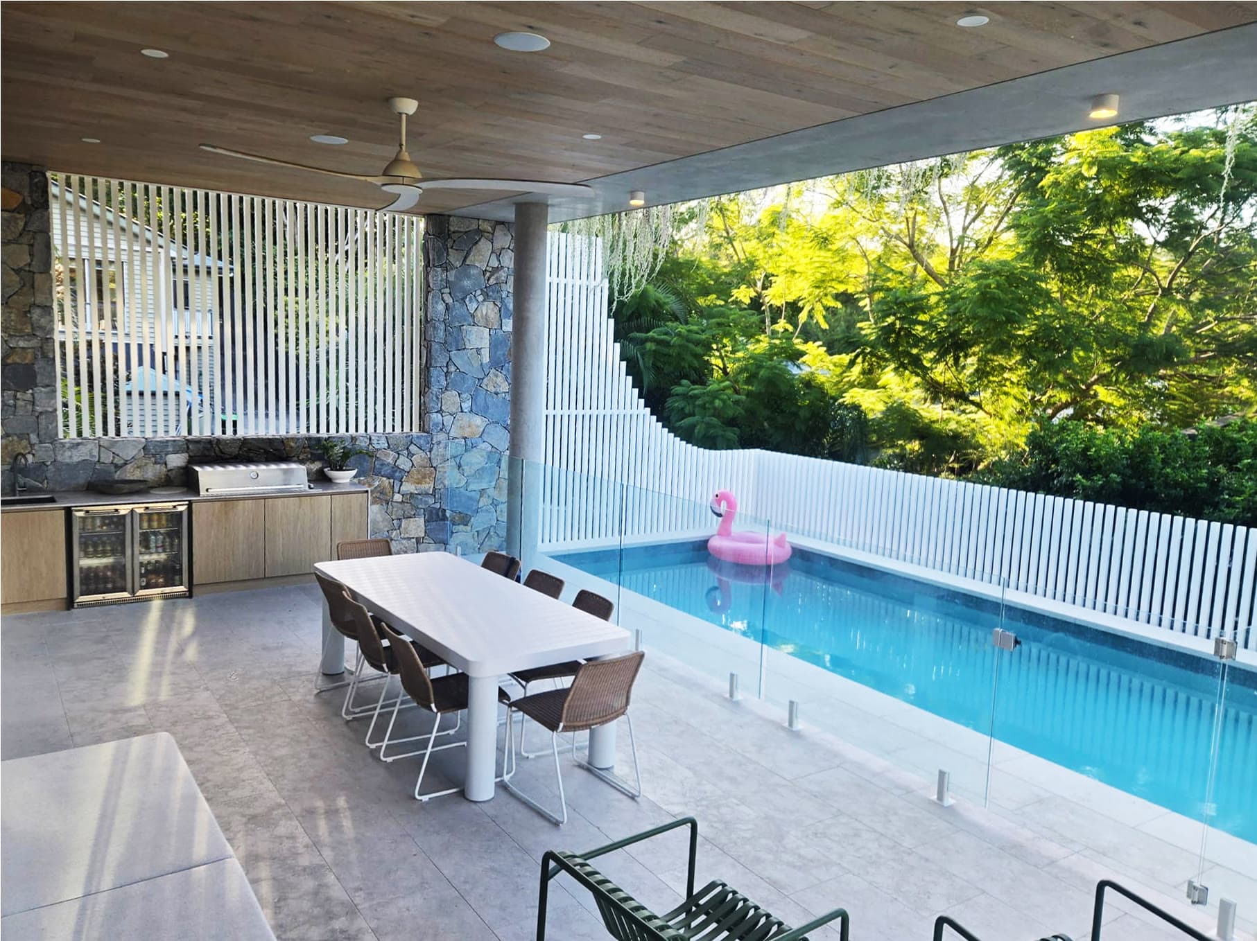 Poolside curved battened privacy screen installed at a residential property